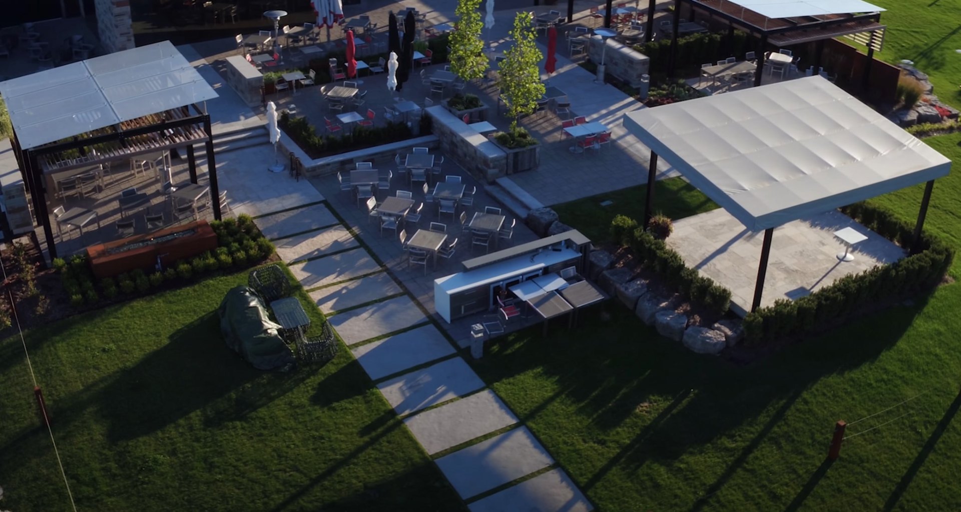 Luxury outdoor living space with fire pit, seating area, and professional landscape lighting