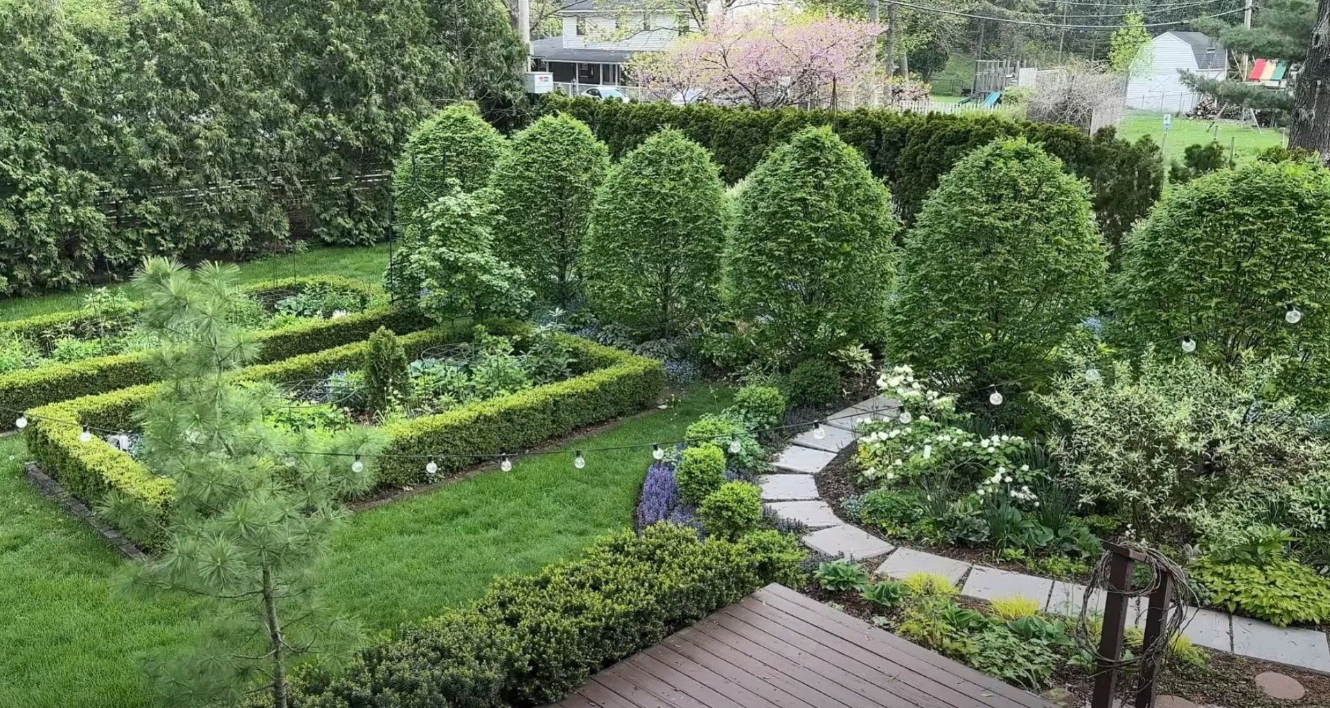 Aerial view of expertly designed formal garden with geometric patterns and lush landscaping